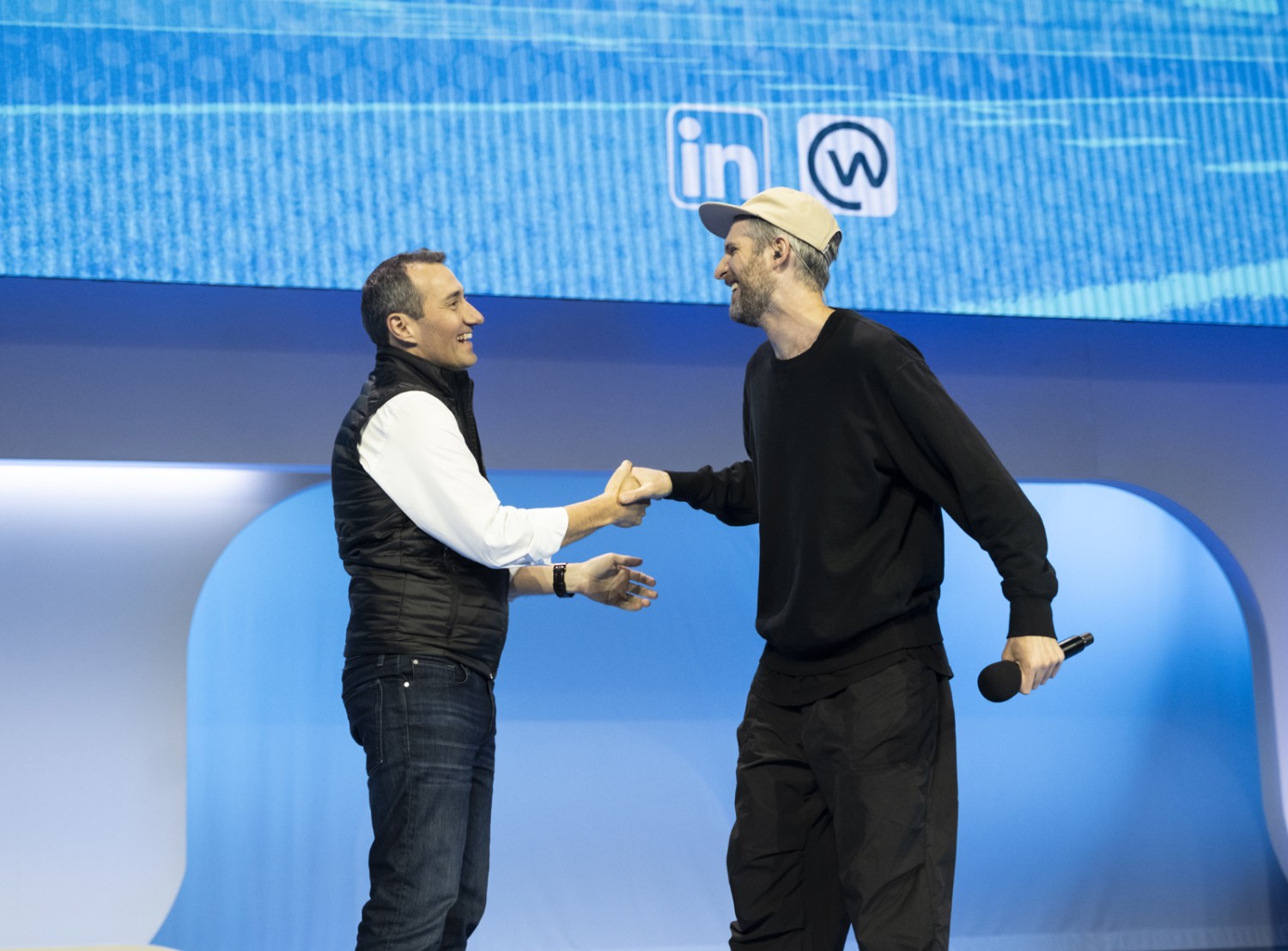 Chris Nicholas and Harry Mack shaking hands on stage